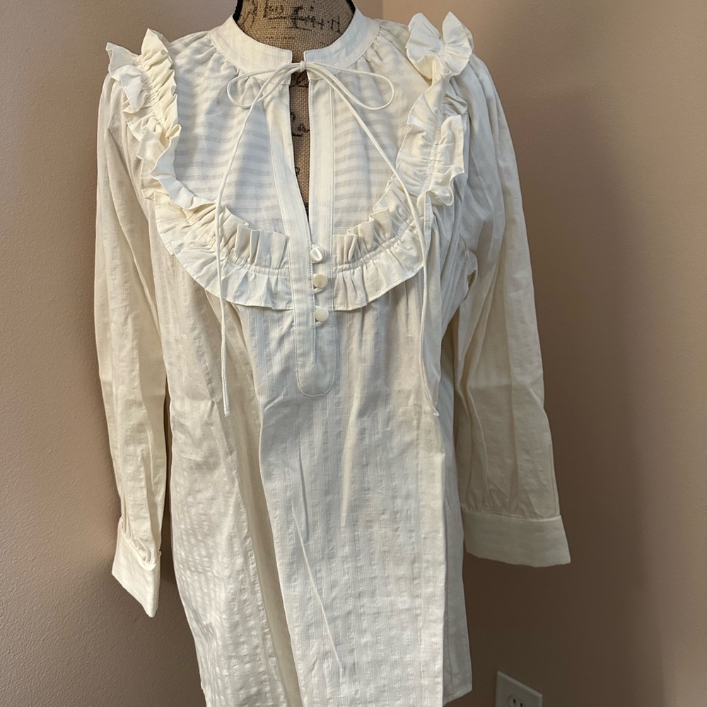 Designer cotton blouse with ruffle details.